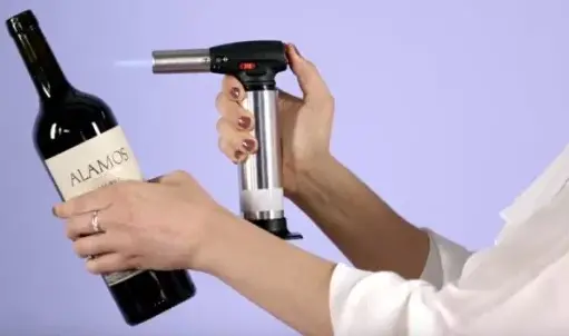 Use flamethrower to open a Wine Bottle without a Corkscrew