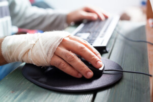 Bandaged hand on mouse